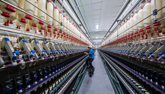 Defying US sanctions Xinjiangs textile industry booms with AI and 5G